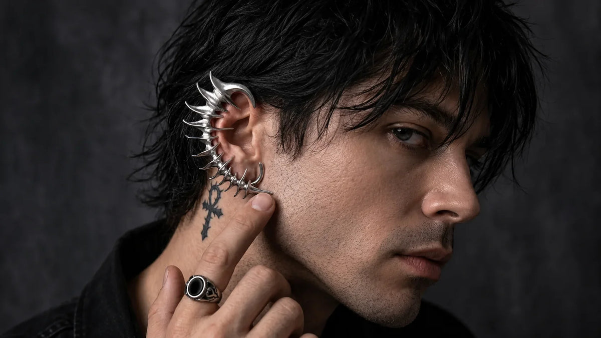 Male model wearing a silver gothic spine ear cuff and black gothic ring