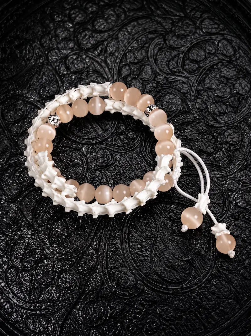 Apricot Glow double-wrap snake bone bracelet with peach beads, silver-tone accents and white beaded cord ends
