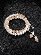 Apricot Glow double-wrap snake bone bracelet with peach beads, silver-tone accents and white beaded cord ends