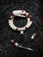 Bloodlance Snake Bone Bracelet, pale preserved snake head bracelet with red bead accents and pointed metal drops