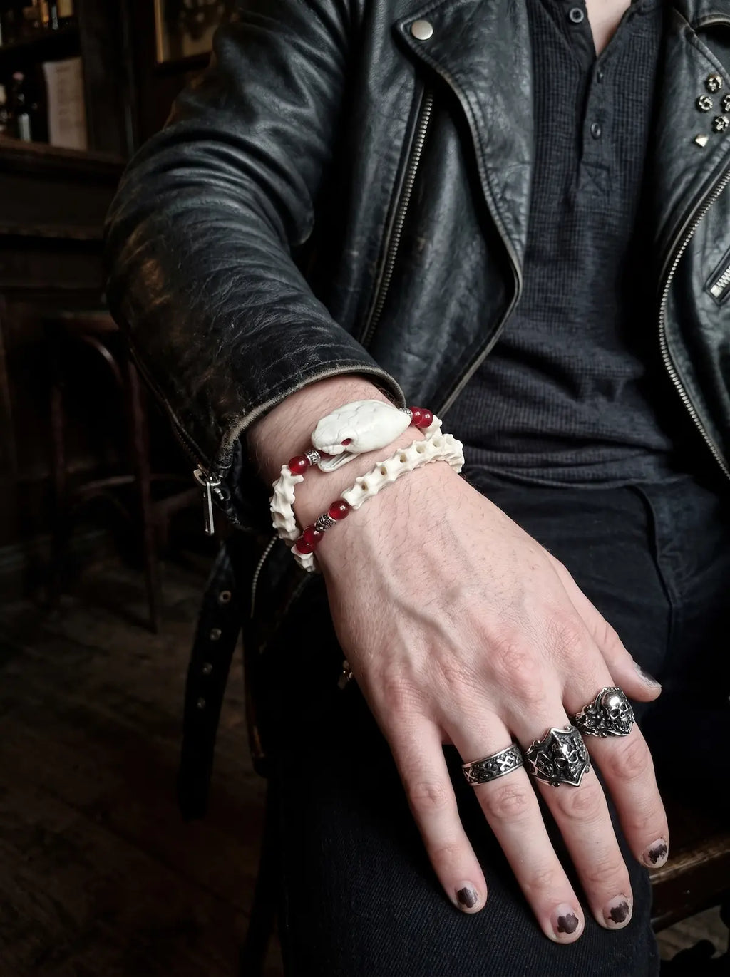 Bloodlance Snake Bone Bracelet, white vertebrae and snake head bracelet worn with dark rings and leather jacket
