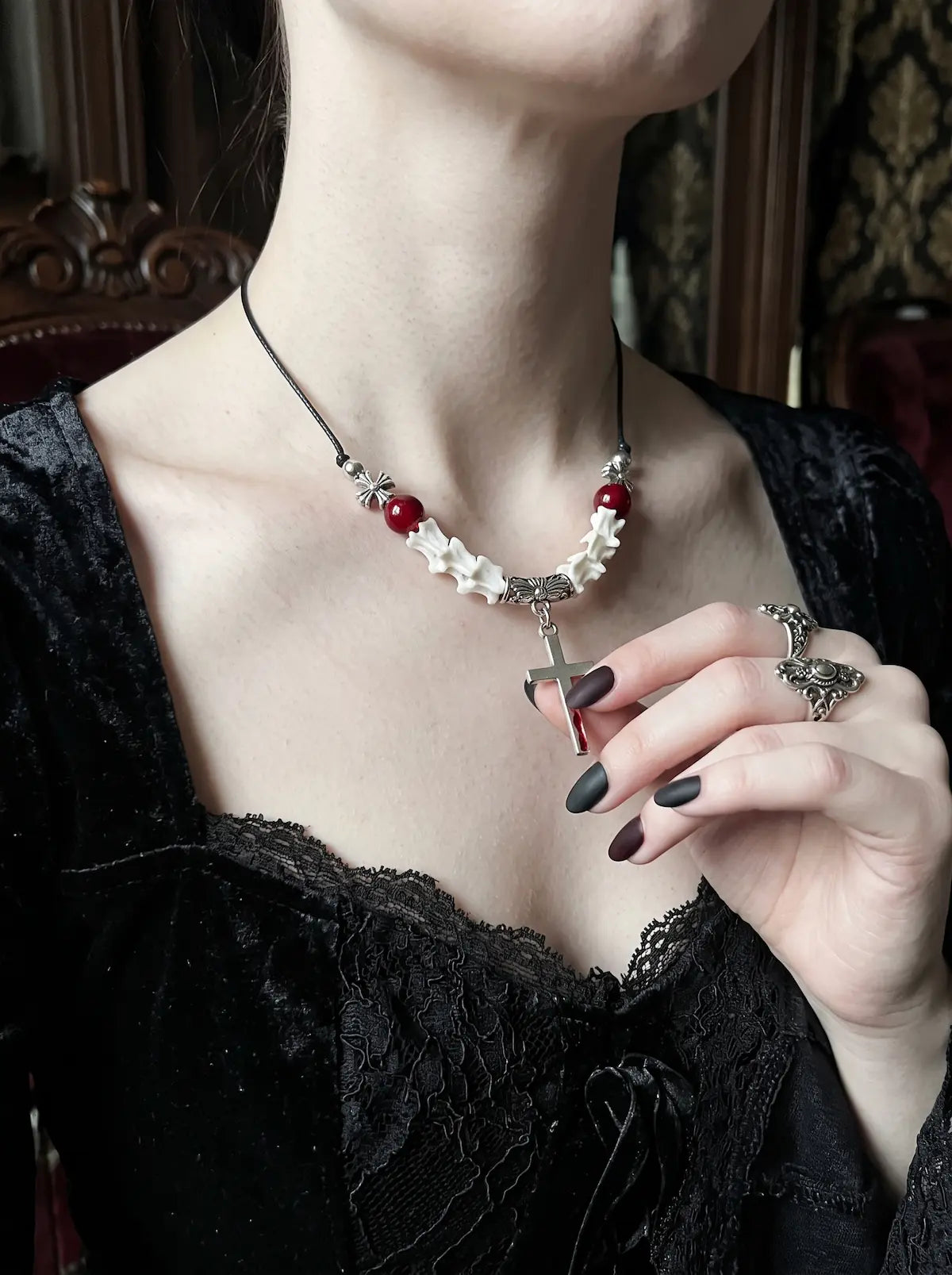 Bloodmark Cross Snake Bone Necklace, red bead and white vertebrae necklace with cross worn at the neckline