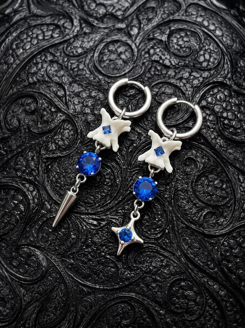 Blue Shard Snake Bone Earrings, pair of pale bone earrings with royal blue beads, star charms and pointed drops
