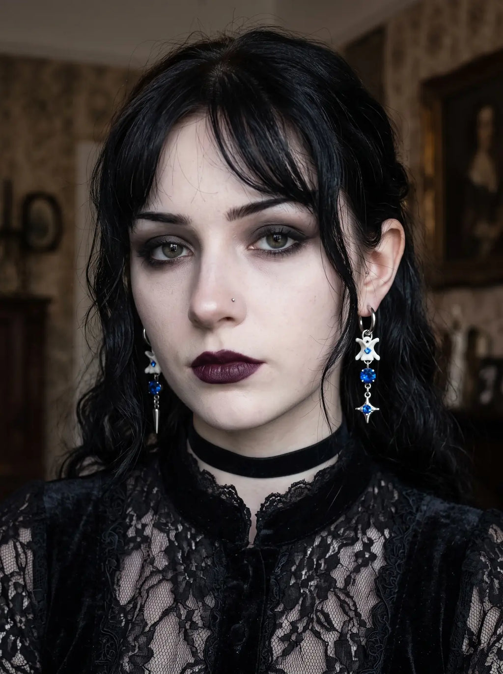Blue Shard Snake Bone Earrings, front portrait displaying the matching blue bead and star drop earrings