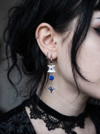 Blue Shard Snake Bone Earrings, side profile wearing a pale vertebrae earring with vivid blue bead details