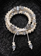 Butterfly Mist layered snake bone bracelet with pale gray beads, silver-tone butterflies and white beaded cord ends