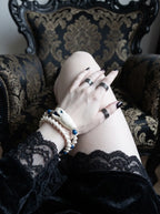 Cobalt Batwing Snake Bone Bracelet, close wrist detail of snake head bracelet with cobalt beads and black lace sleeve