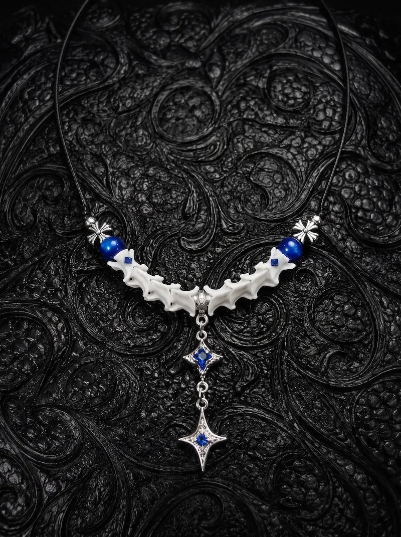 Cobalt Starfall Snake Bone Necklace, pale vertebrae necklace with cobalt blue beads and dangling star-shaped metal pendant