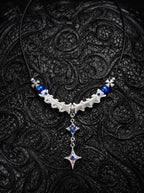 Cobalt Starfall Snake Bone Necklace, pale vertebrae necklace with cobalt blue beads and dangling star-shaped metal pendant