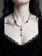 Cobalt Starfall Snake Bone Necklace, blue and white snake bone necklace worn above a black lace neckline
