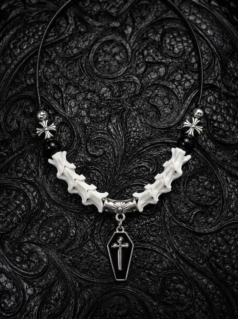 Coffin Oath Snake Bone Necklace, pale snake vertebrae necklace with dark beads and a coffin-shaped metal pendant