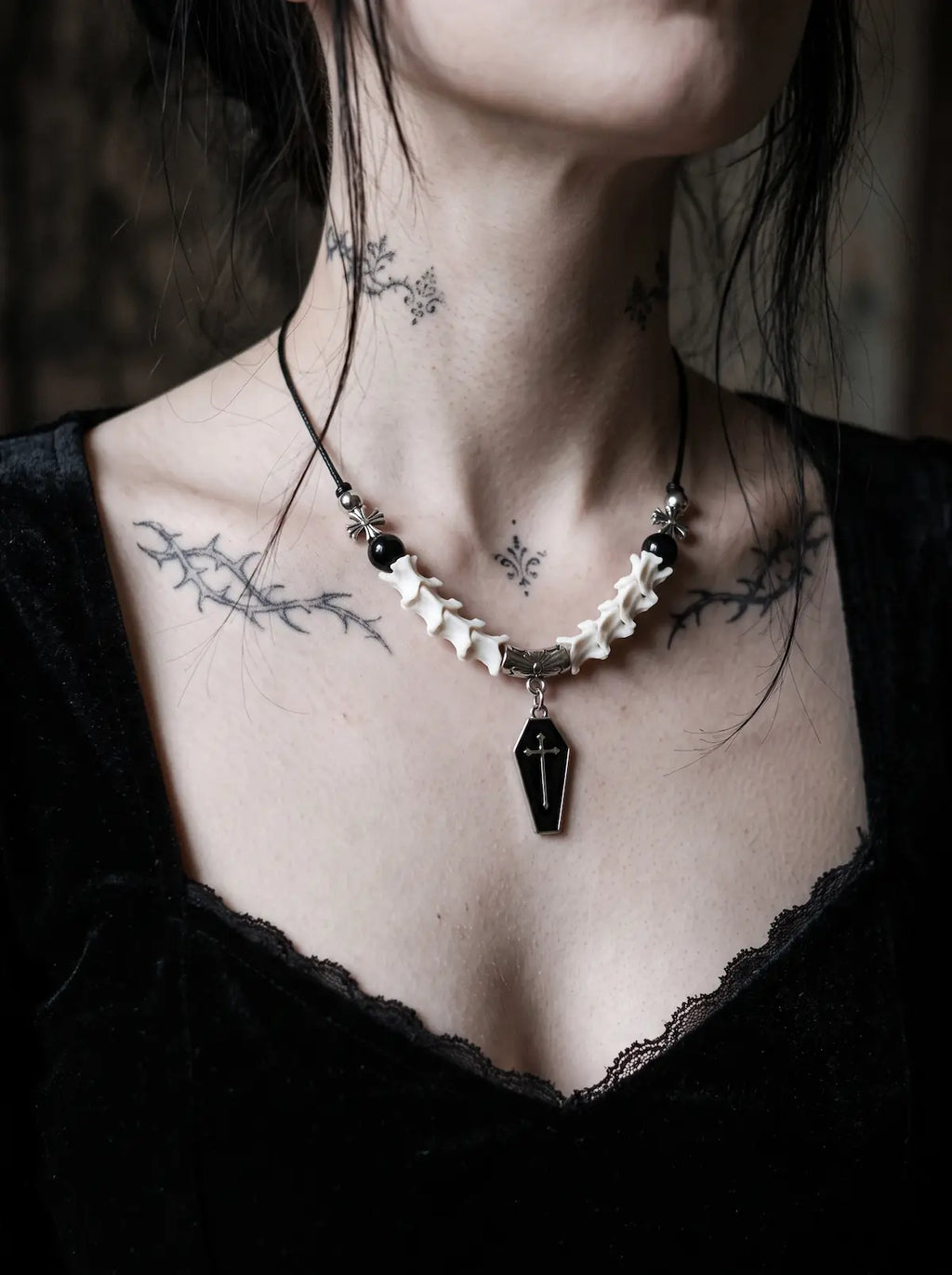 Coffin Oath Snake Bone Necklace, white snake bone and coffin pendant necklace worn over a black corset top