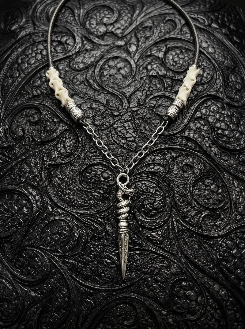 Coilblade Snake Bone Necklace, white vertebrae necklace with a long antique silver-tone dagger pendant