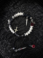 Crimson Rose snake bone bracelet with black and gray beads, red roses, a small cross and dangling sword details