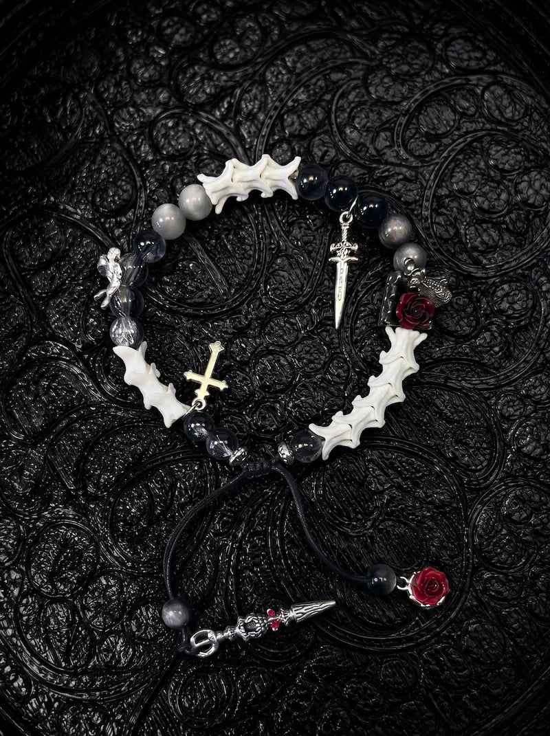 Crimson Rose snake bone bracelet with black and gray beads, red roses, a small cross and dangling sword details