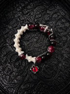 Crimson Serpent Eye snake bone bracelet with red and black beads, a silver-tone serpent and a red reptilian eye charm