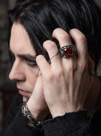 Man wearing a Dragon Talon Zircon Ring with a large red gemstone and gothic claw setting