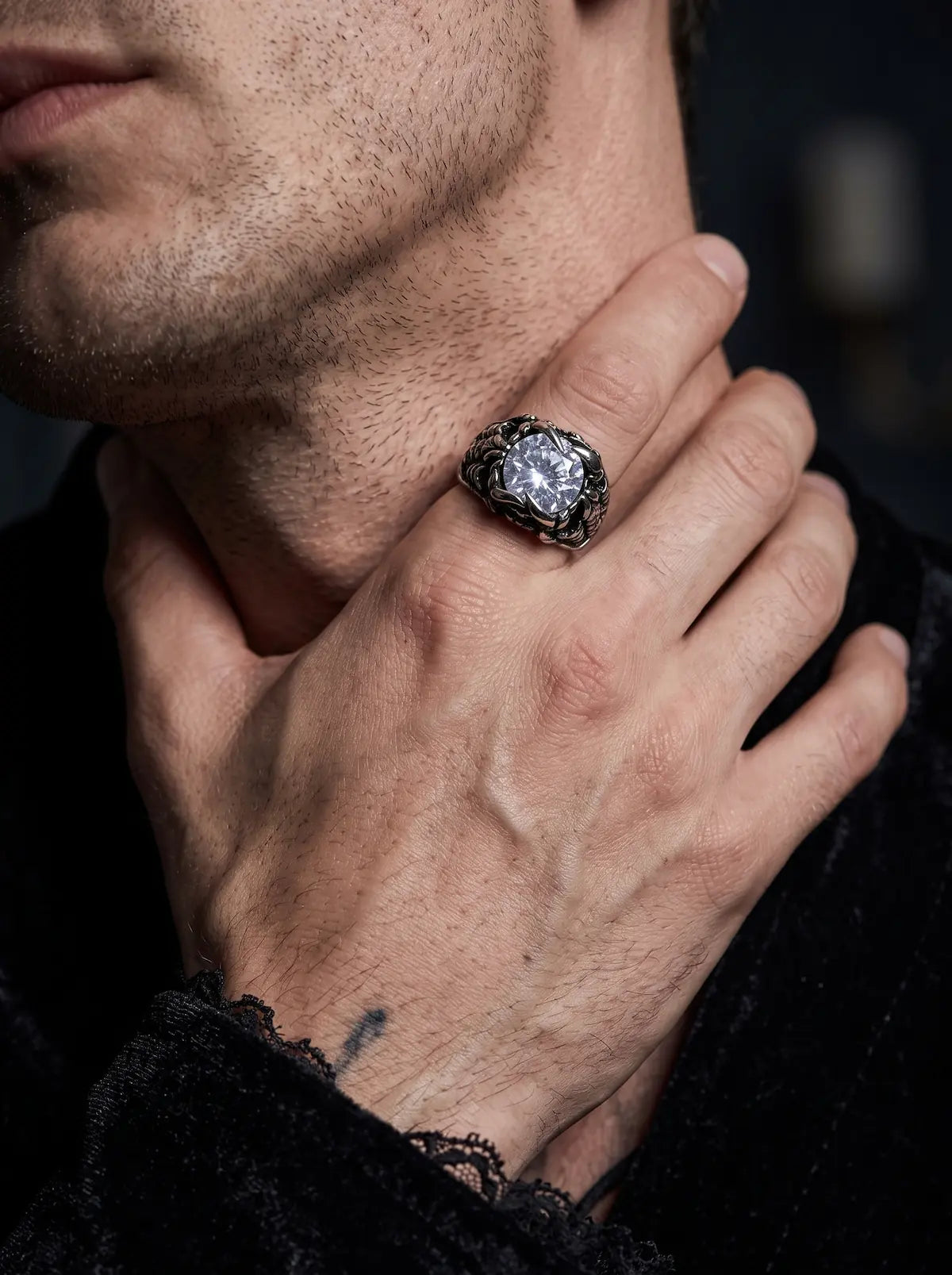 Man wearing a Dragon Talon Zircon Ring with a large clear gemstone in a gothic claw setting