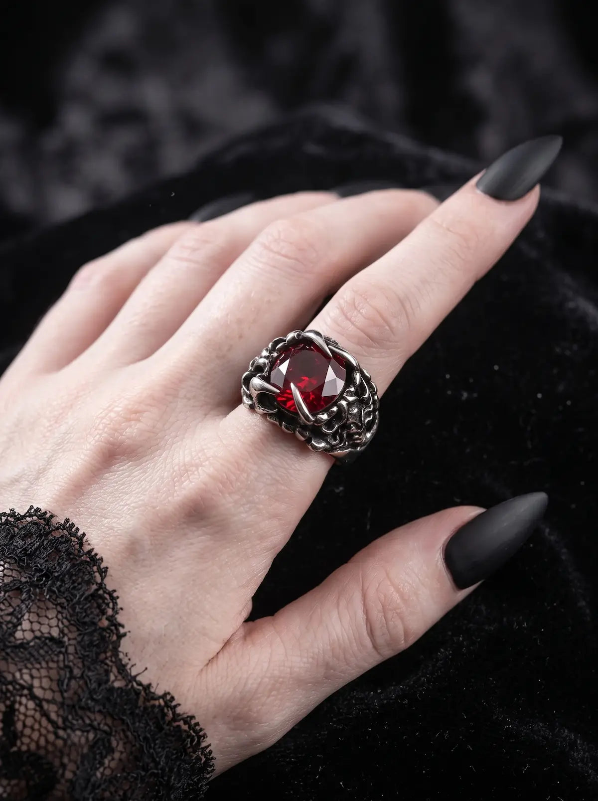 Woman wearing a Dragon Talon Zircon Ring with a large red gemstone and gothic claw setting