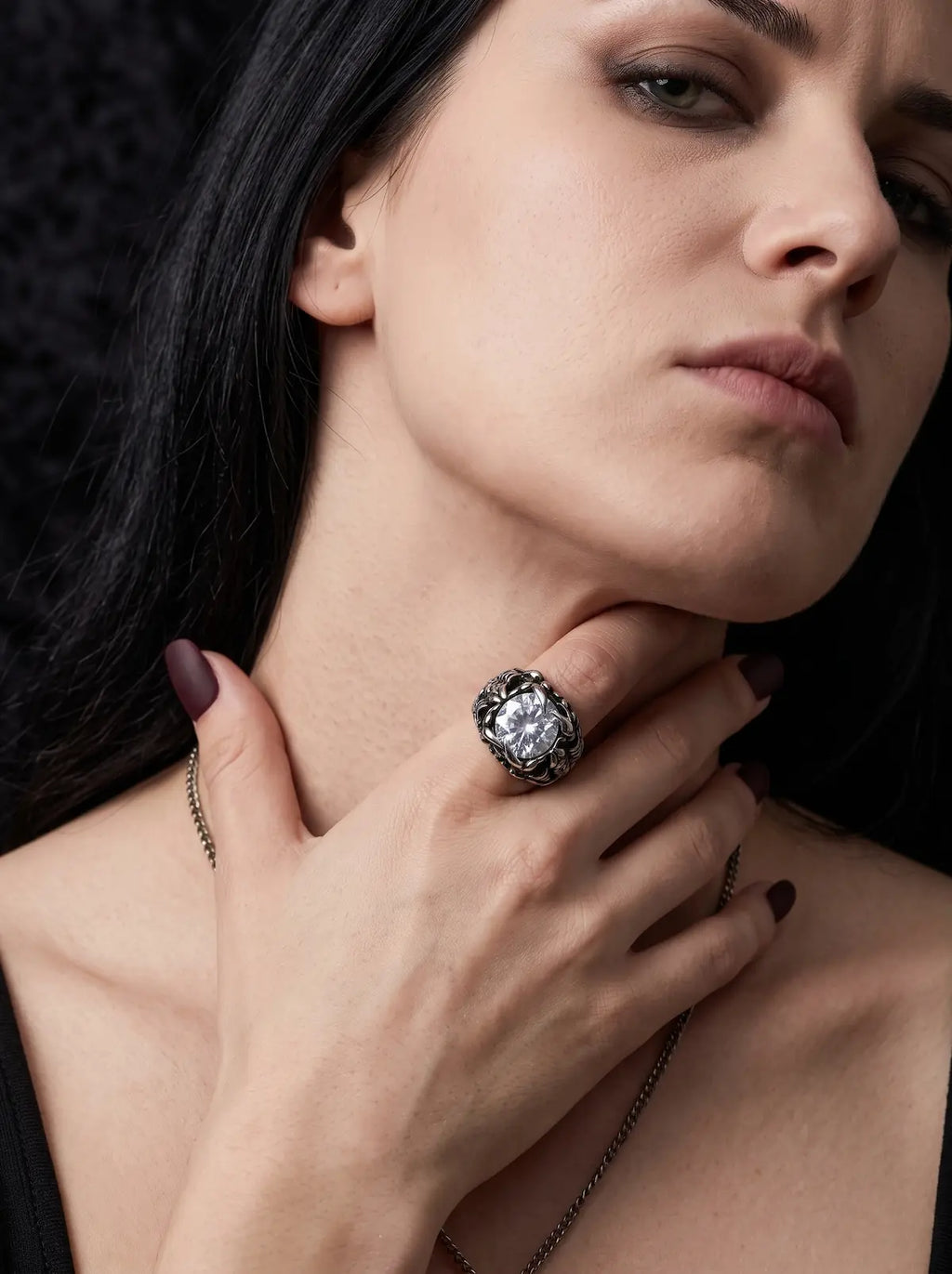 Woman wearing a Dragon Talon Zircon Ring with a large clear gemstone in a gothic claw setting