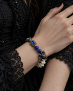 Duskdrake Snake Bone Bracelet, wrist showing cobalt beads, sculpted dark metal accents and white vertebrae