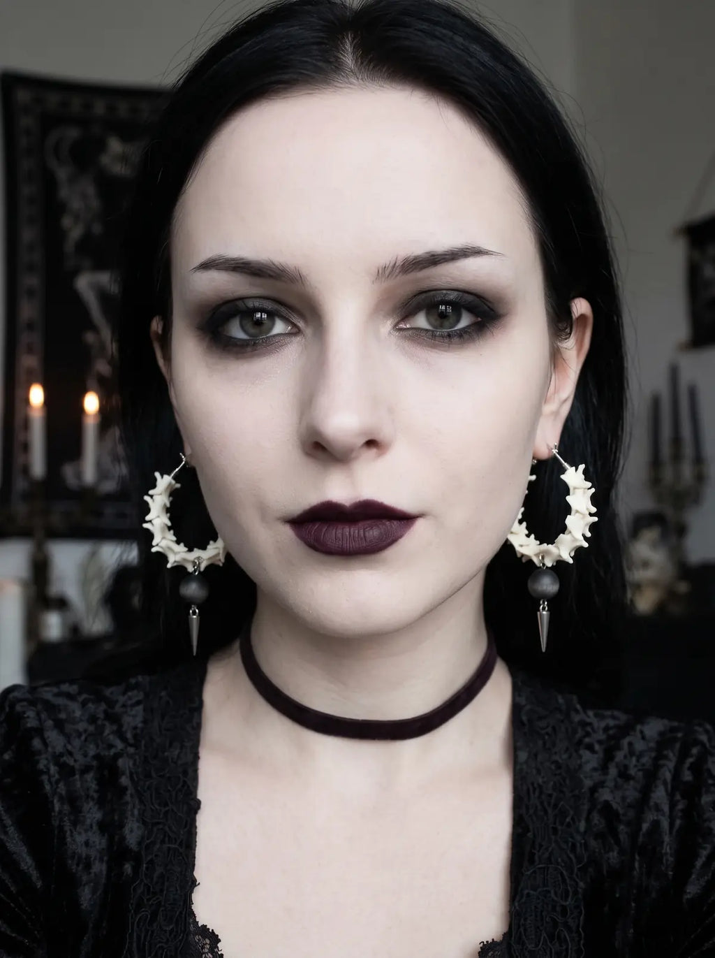 Ebon Thorn snake bone hoop earrings worn as a pair with a black choker in a front-facing portrait