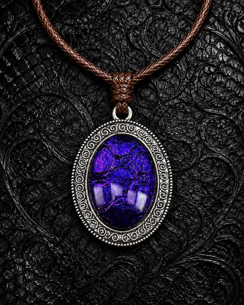 Eclipse Relic snakeskin pendant necklace in Arcane Violet, displayed on black textured fabric