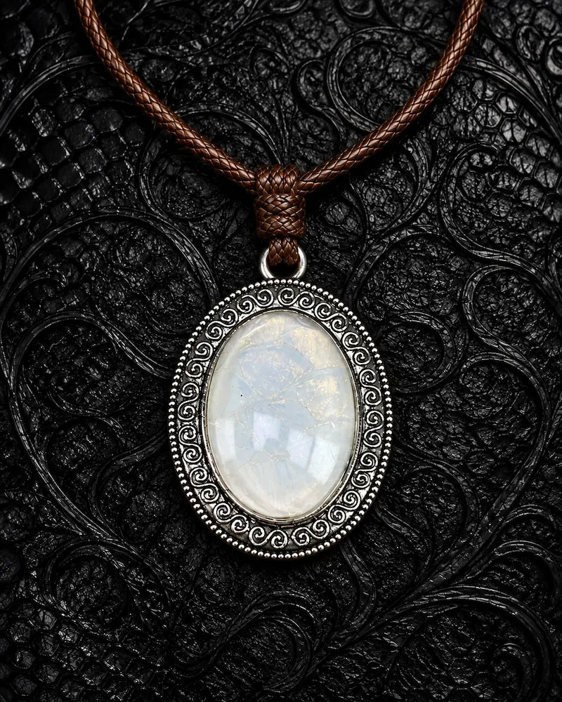 Eclipse Relic snakeskin pendant necklace in Ghost Opal, with a pale iridescent center and silver-tone frame