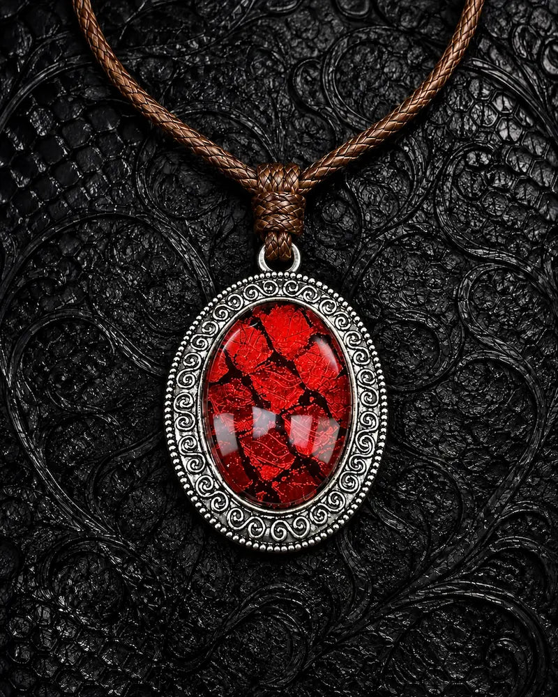 Eclipse Relic snakeskin pendant necklace in Blood Crimson, with a silver-tone oval frame and brown braided cord