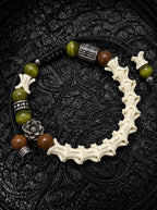 Forest Bloom snake bone bracelet with olive green and brown beads, a silver-tone flower and black adjustable cords