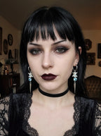 Glacial Spike Snake Bone Earrings, portrait of model wearing both light blue accent snake bone drop earrings