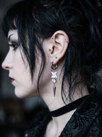 Glimmerthorn Snake Bone Earrings, side portrait displaying dangling vertebrae earring and silver-tone point