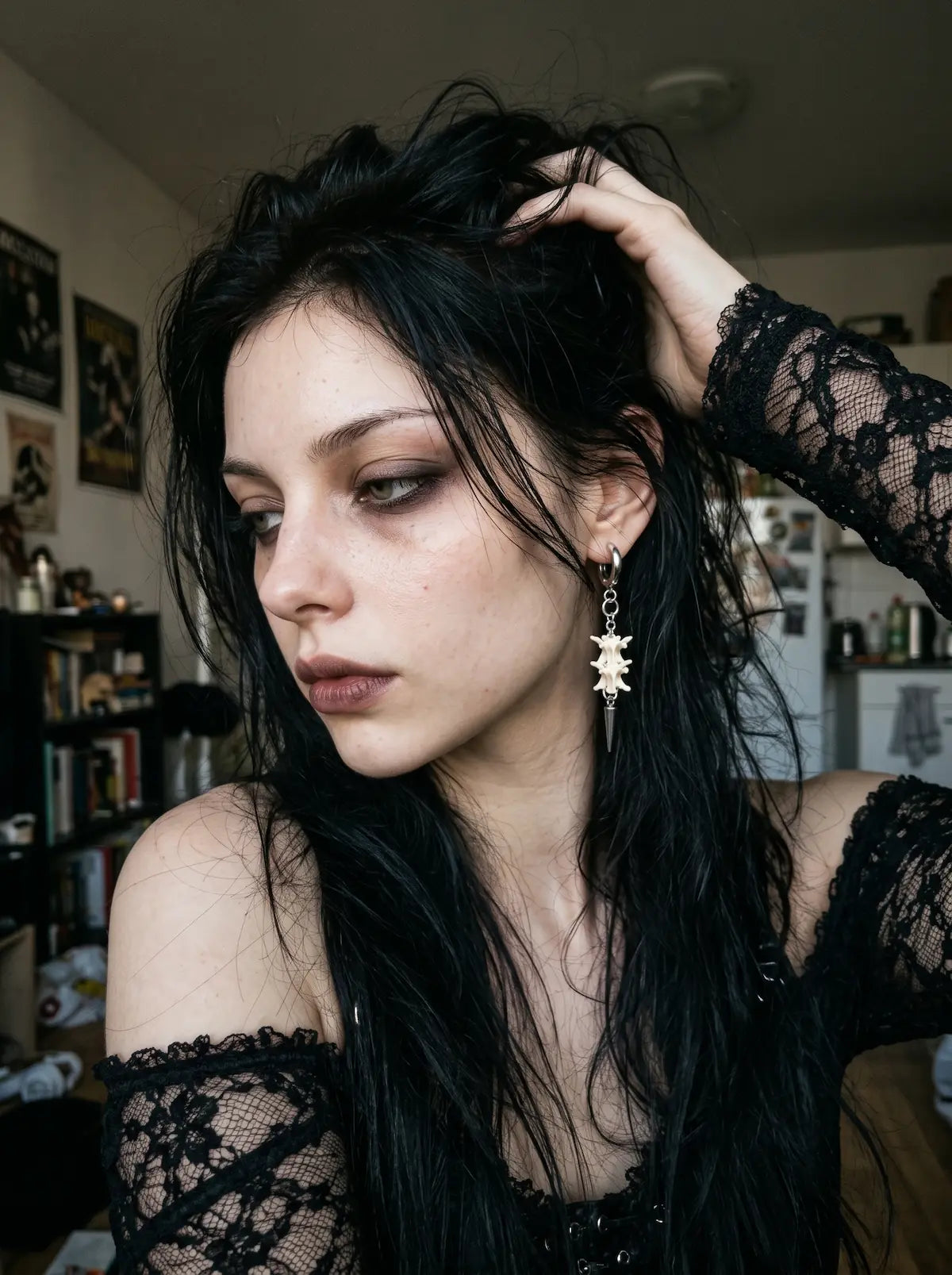 Gravechain Spike snake bone earring worn with black lace and hair lifted away from the ear