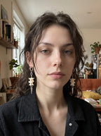 Gravechain Spike snake bone earrings worn as a pair in a front-facing indoor portrait