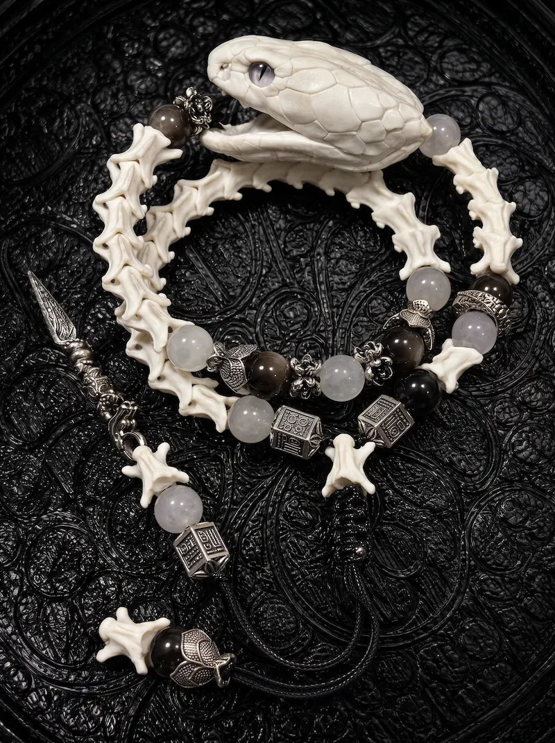 Ivory Serpent Head layered snake bone bracelet with a sculpted ivory-tone snake head, pale and dark beads and black cords