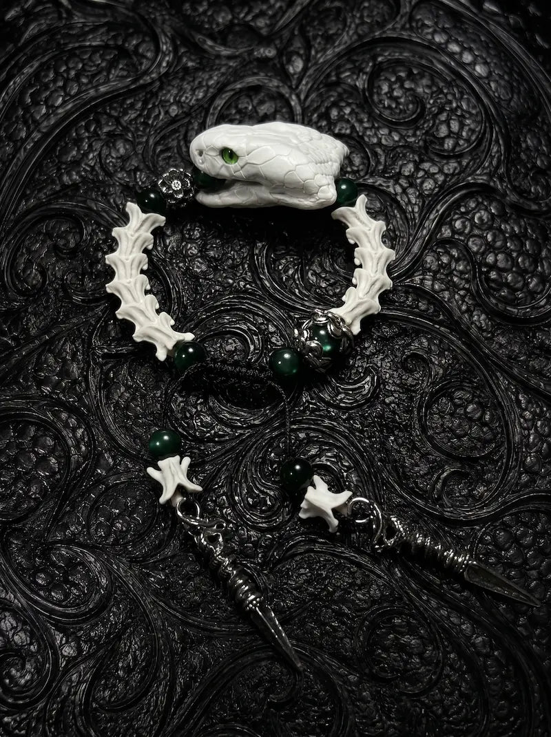 Jadefang Snake Bone Bracelet, preserved pale snake head bracelet with green beads and dangling metal charms
