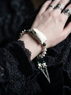 Jadefang Snake Bone Bracelet, snake head and green bead bracelet worn on the back of a hand with rings