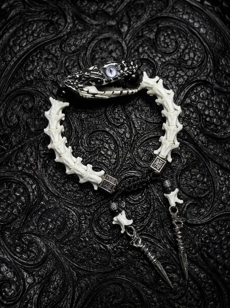 Kingshade Snake Bone Bracelet, white vertebrae bracelet with dark preserved snake head and hanging spear charms