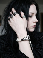 Kingshade Snake Bone Bracelet, snake head bracelet on the wrist as the model adjusts dark hair