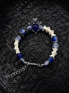 Midnight Guardian snake bone bracelet with blue and clear beads, an ornate blue centerpiece and a silver-tone clasp