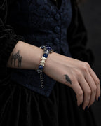 Side view of the Midnight Guardian snake bone bracelet on the wrist, showing its dangling extension chain