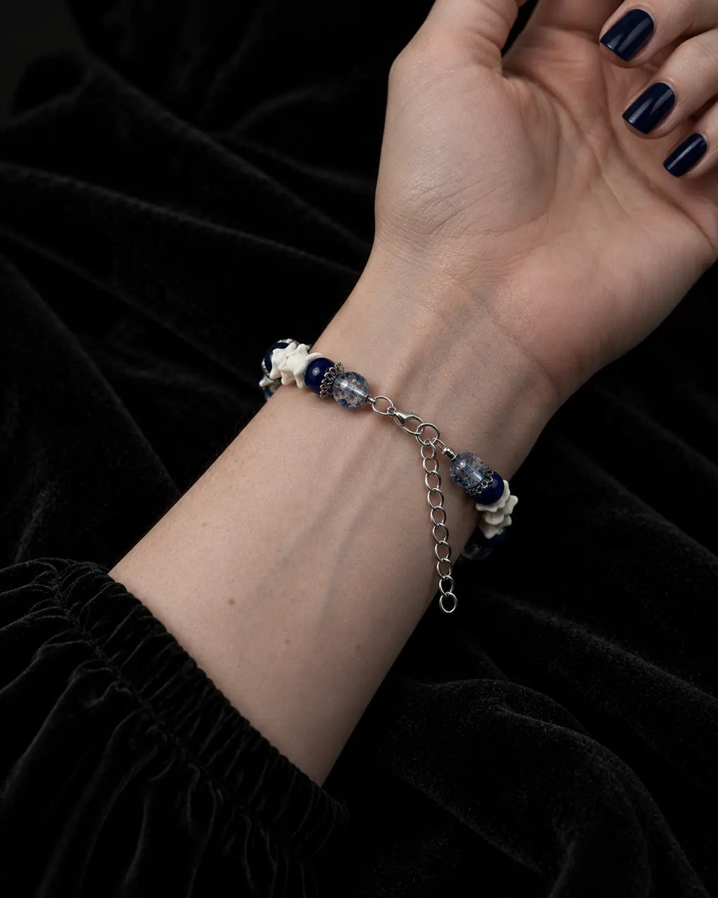 Palm-up view of the Midnight Guardian snake bone bracelet showing the metal clasp and extension chain