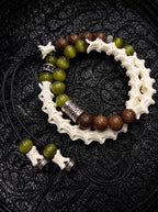 Mosswood double-wrap snake bone bracelet with olive green and brown beads, engraved spacers and black beaded cord ends
