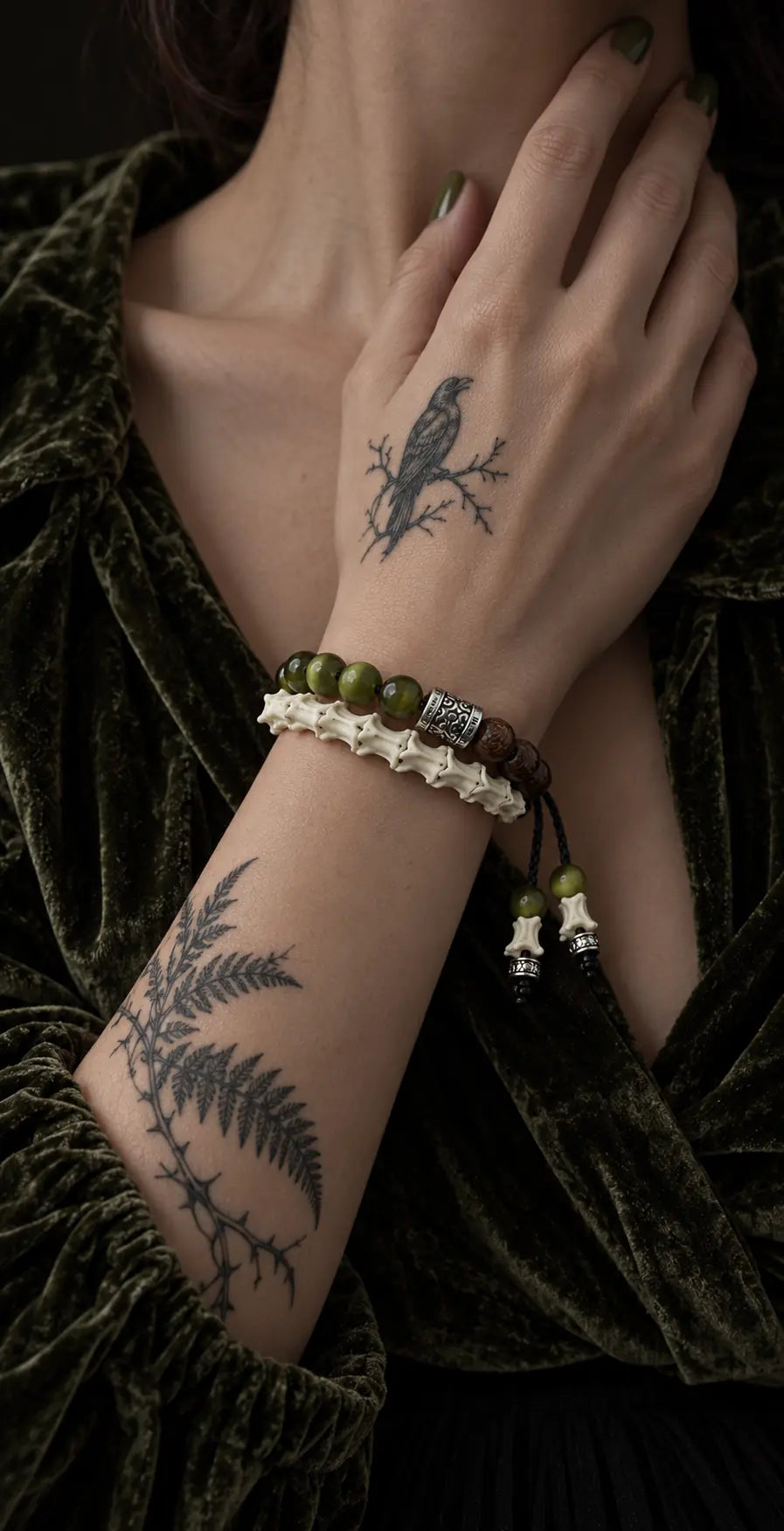 Mosswood snake bone bracelet worn in two rows with the hand resting near the neck