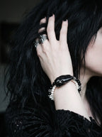 Nightreign Snake Bone Bracelet, black snake head bracelet worn on a wrist as the model touches dark hair