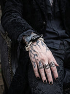 Nightreign Snake Bone Bracelet, white bone and dark snake head bracelet over a tattooed hand in black clothing