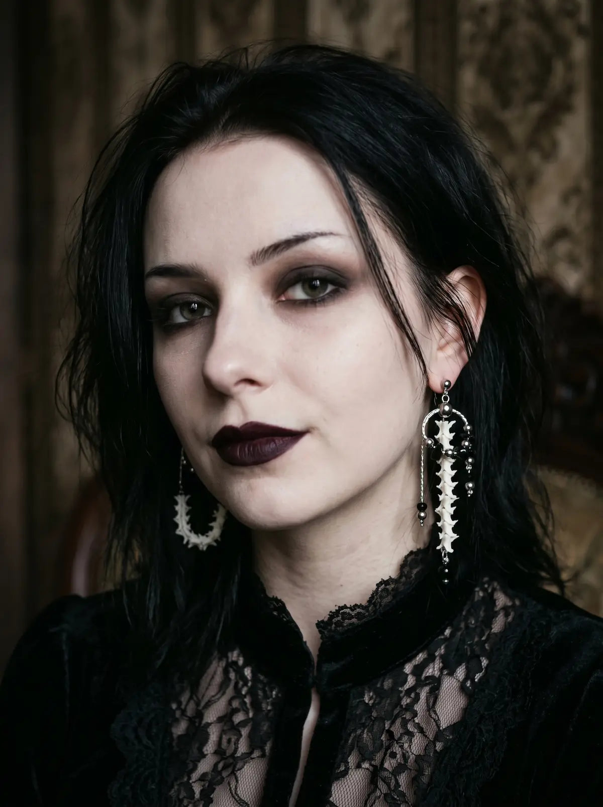 Nocturne Arc Snake Bone Earrings, portrait showing the mismatched bone hoop and long drop earrings together
