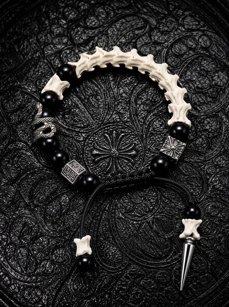 Obsidian Fang snake bone bracelet with black beads, a serpent accent and a silver-tone spike on black adjustable cords