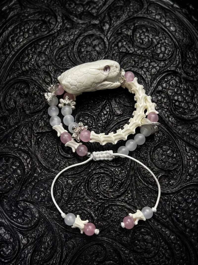 Petalshade Snake Bone Bracelet, preserved pale snake head bracelet with soft pink beads and a black cord tie