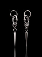 Pair of Razor Fang Spike Earrings with silver hoops and long pointed spike pendants on a black background